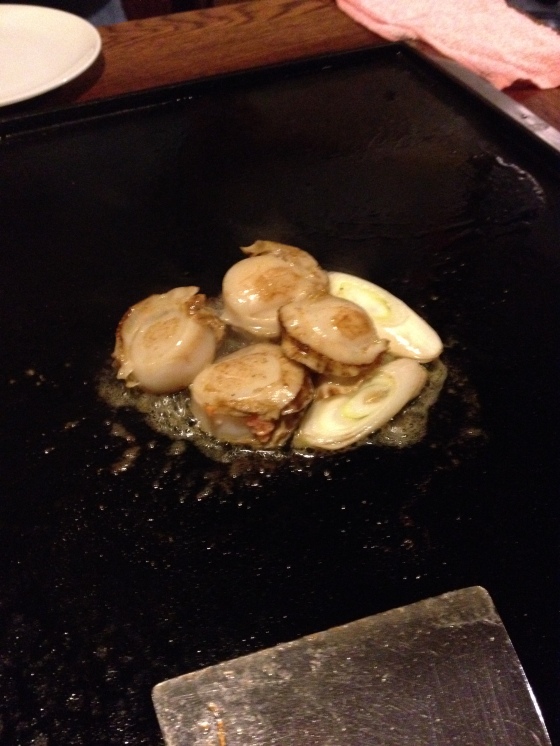 Plump scallops being sauted in lard 